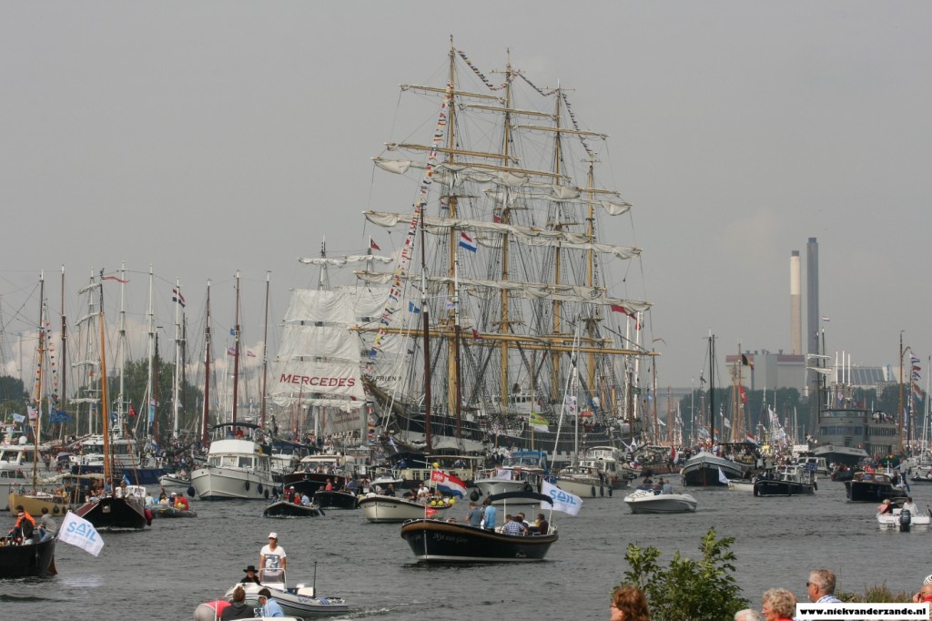 The Kruzenshtern surrounded by many small boats.