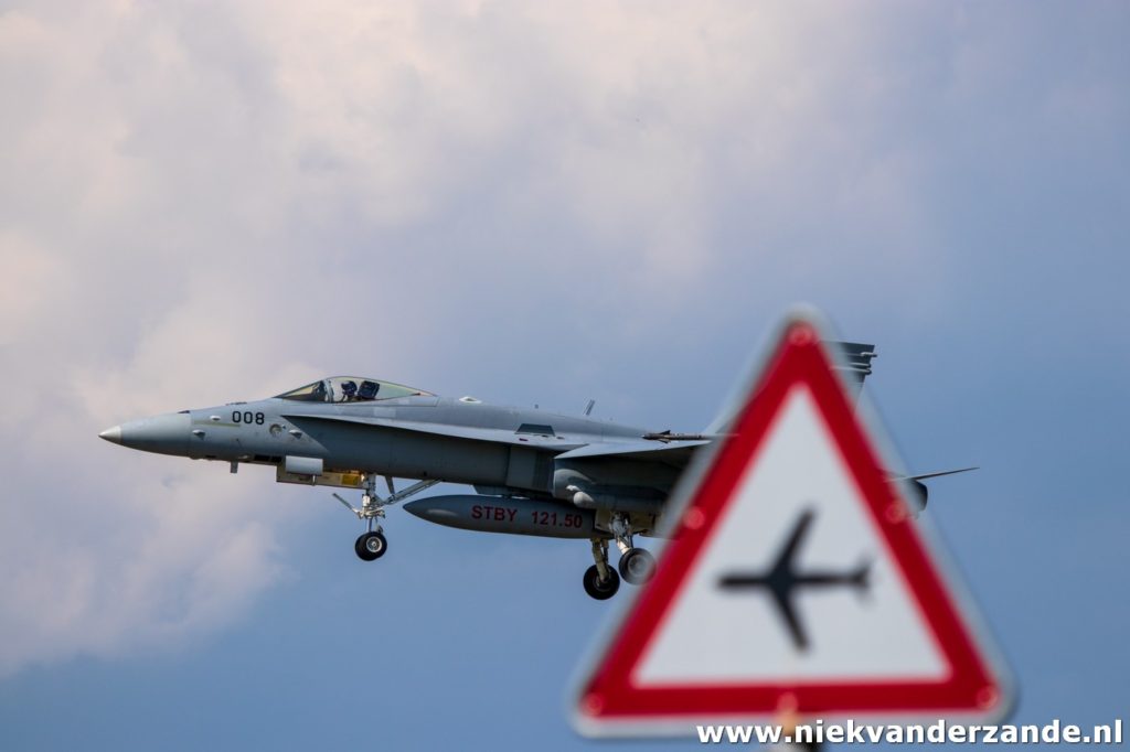 Hornet landing with traffic sign